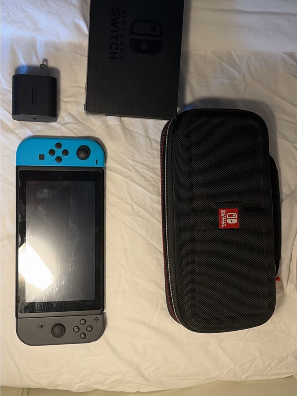 Nintendo Switch with Turquoise Left Joy‑Con and Gray Right Joy‑Con + Carry Case